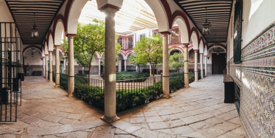 Seville: Hospital de los Venerables Ticket with Audio Guide - The Courtyard and Patio: Orange Trees, Wooden Gates, and a Stage for Theater